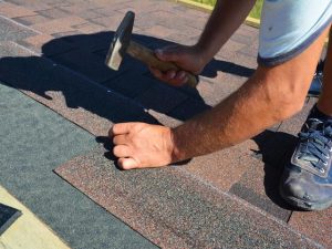 Roofing contractor installing roof tiles